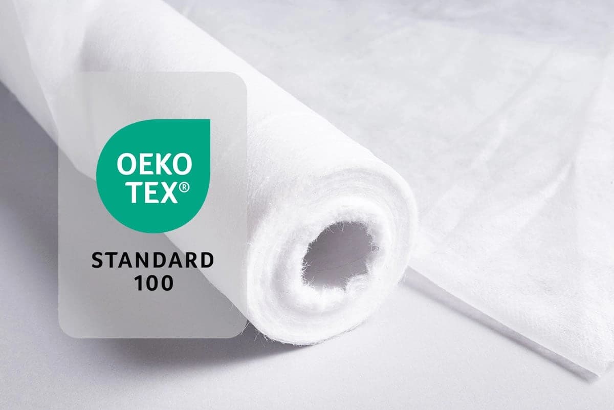 OEKO-TEX® STANDARD 100 certification logo displayed alongside a roll of white spunlace nonwoven fabric