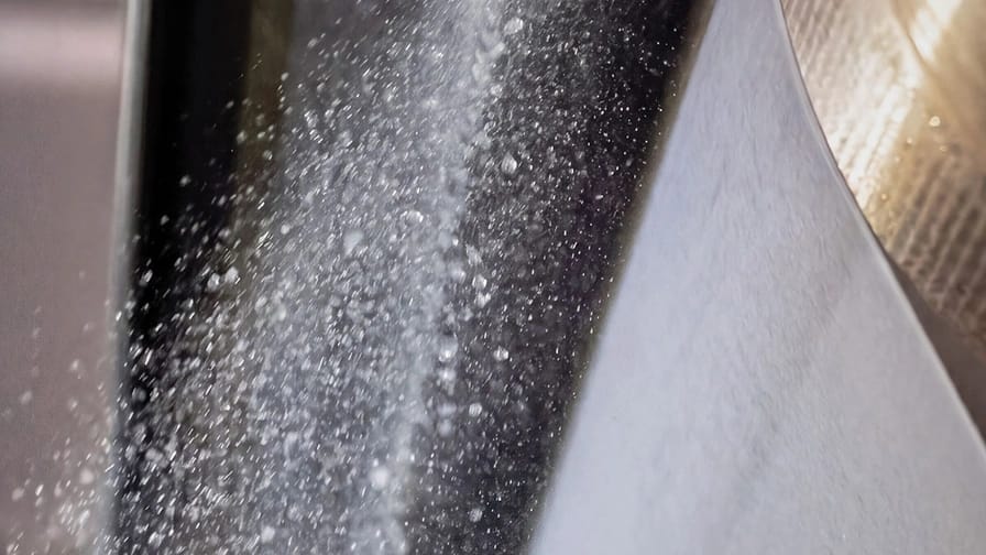 Close-up photo taken during the pultrusion process of a nonwoven fabric at DeatexGroup’s production facilities.