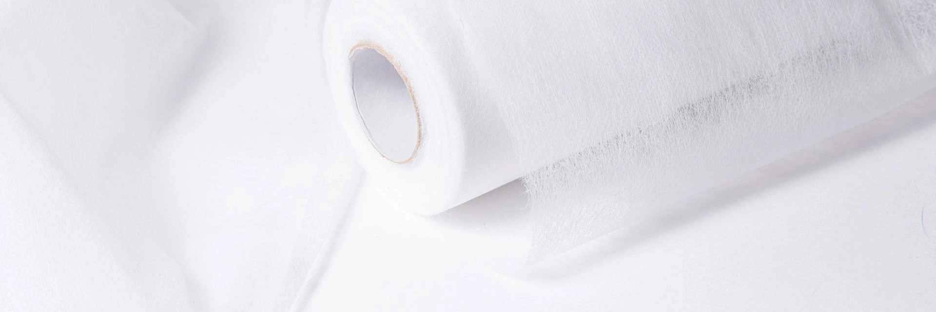 Roll of white OEKO-TEX® STANDARD 100 certified spunlace nonwoven fabric by DeatexGroup